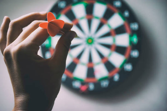 A darts player aiming at his target