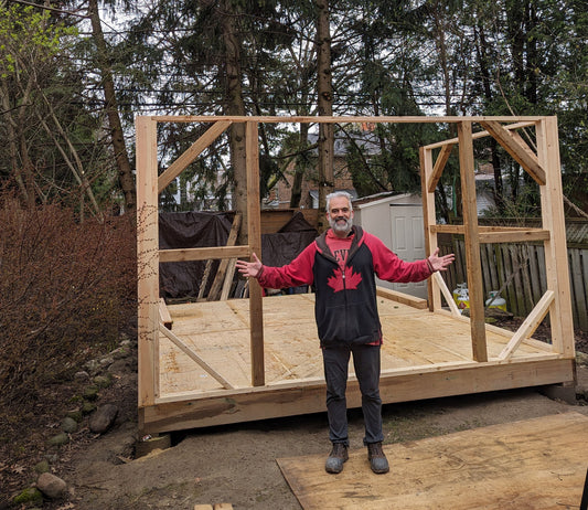 The shops foundation and floor are in place. The frame is half finished.