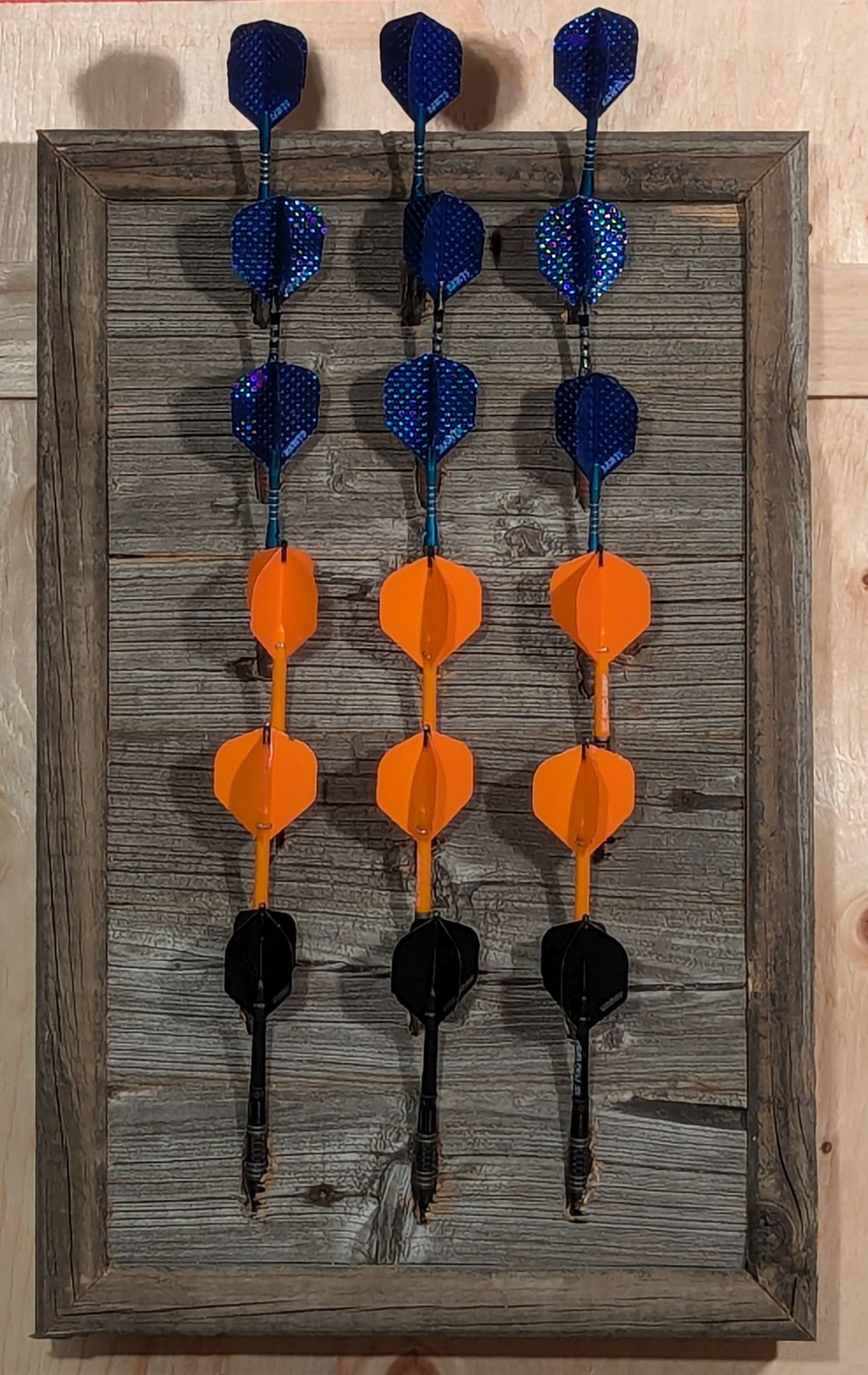 A Barn Board darts holder, made of reclaimed wood, than can display 6 sets of darts (18 darts).