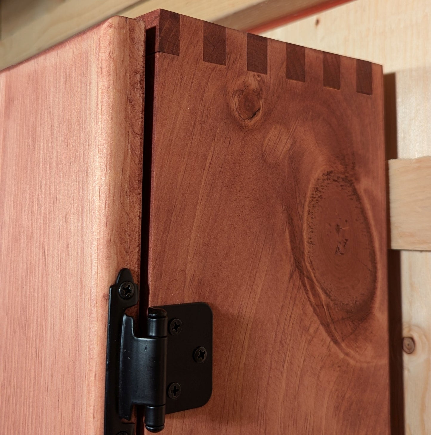 A dartboard cabinet featuring box joint joinery beautifully accentuated by the Red Sedona stain.