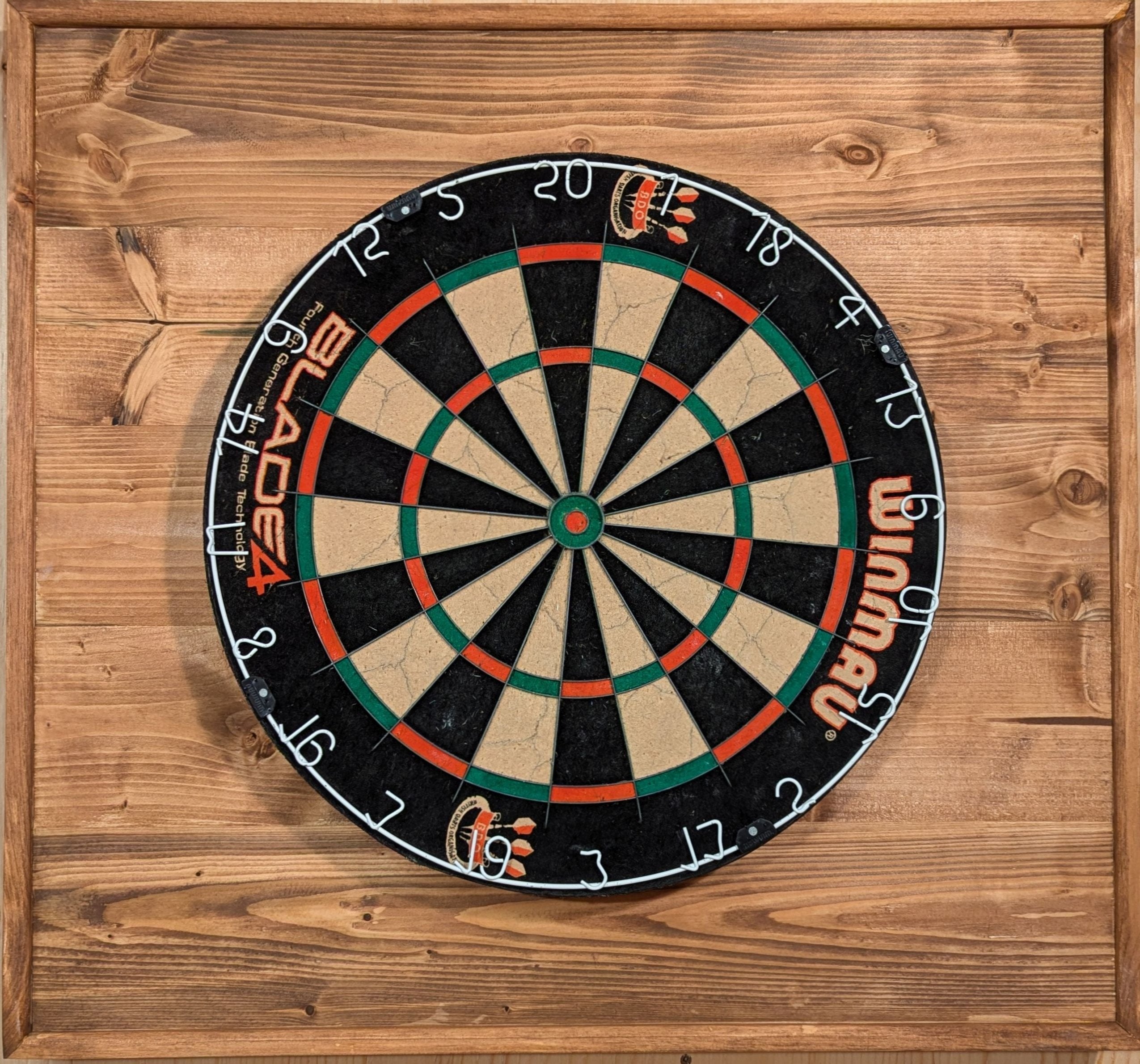 A darts backboard finished in special walnut.