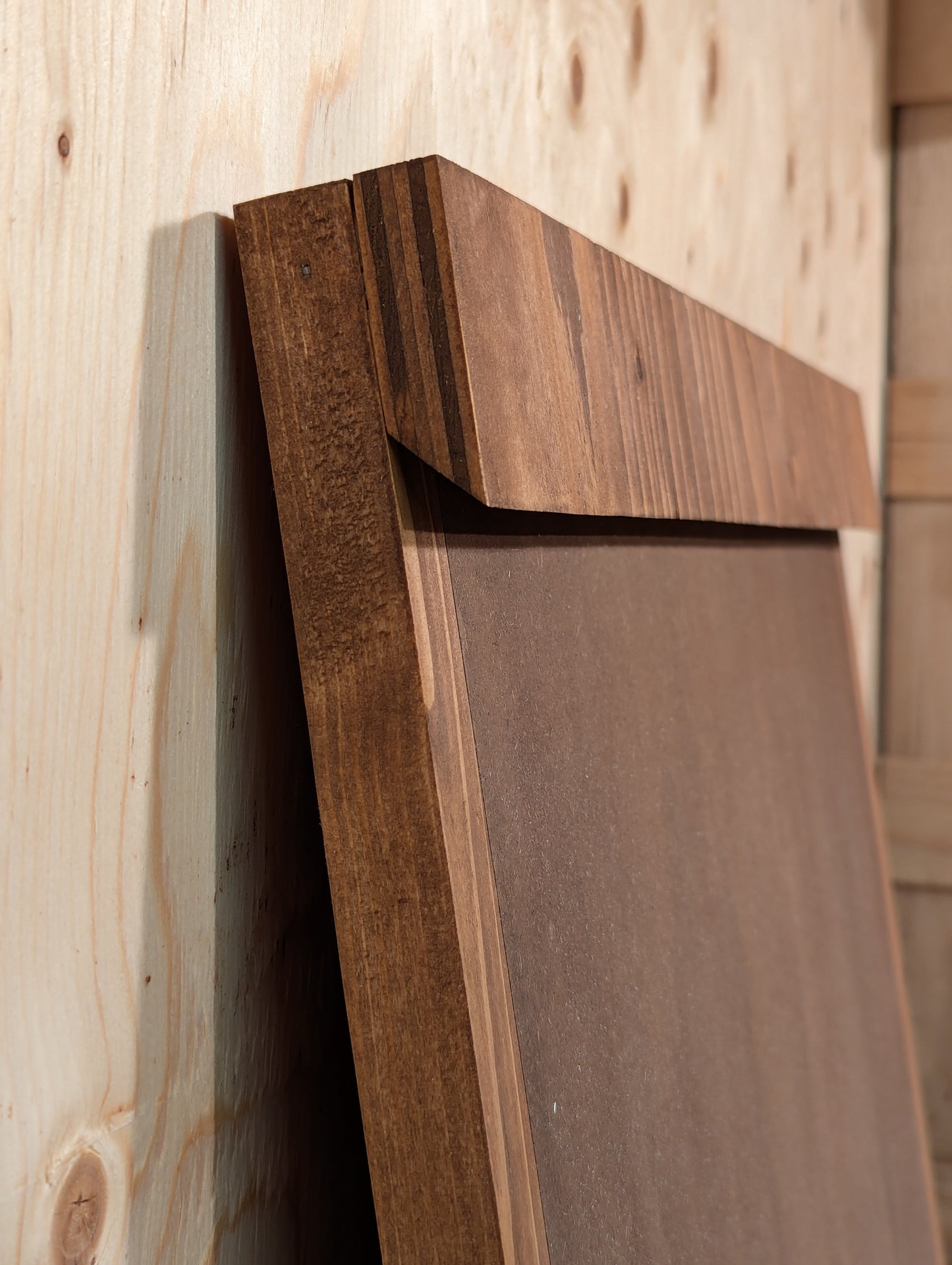 The French cleat system mounted to the back of a darts scoreboard. Stained in Special Walnut color.