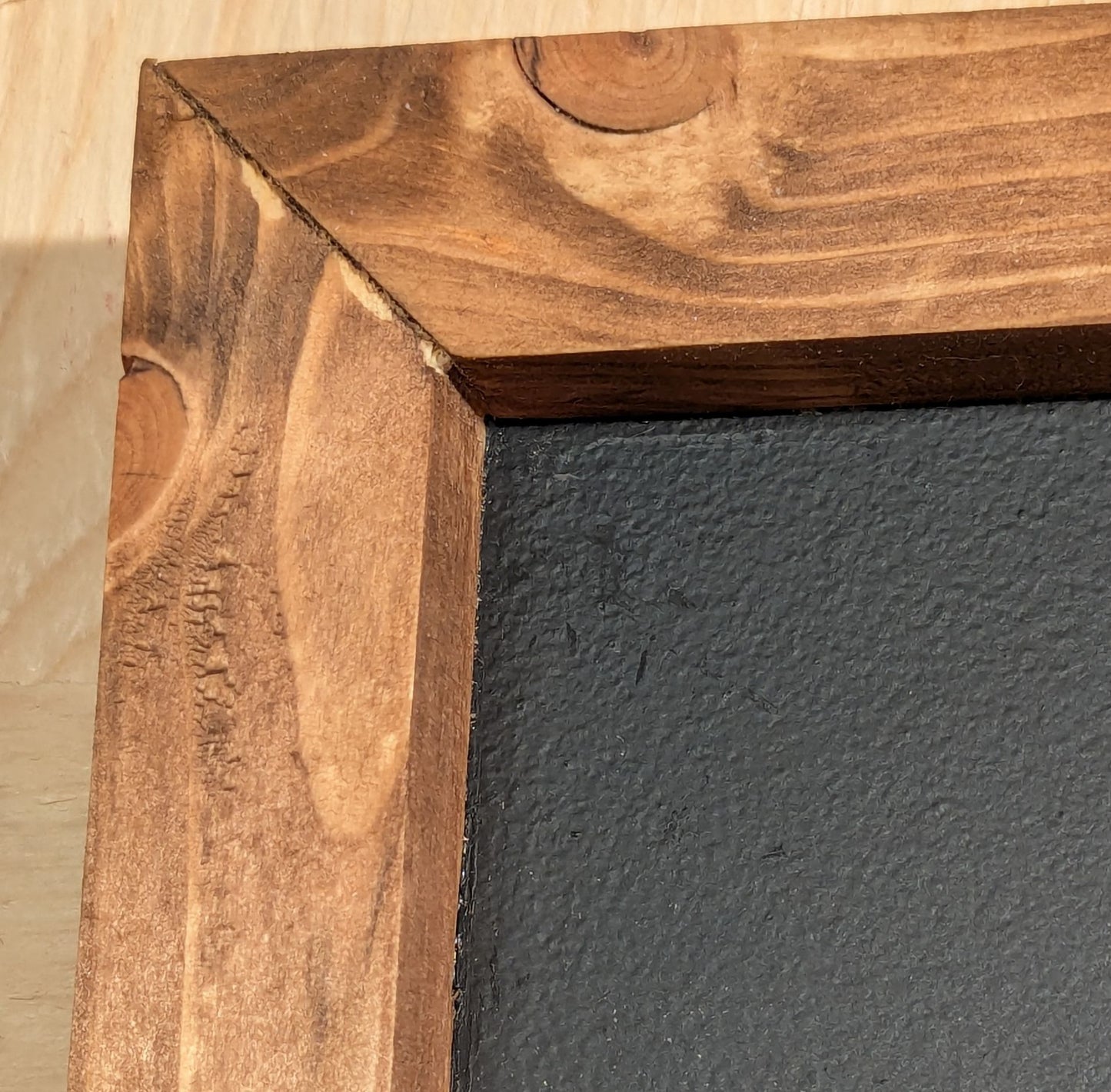 The mitered corner of the darts scoreboard. Stained in Special Walnut color.