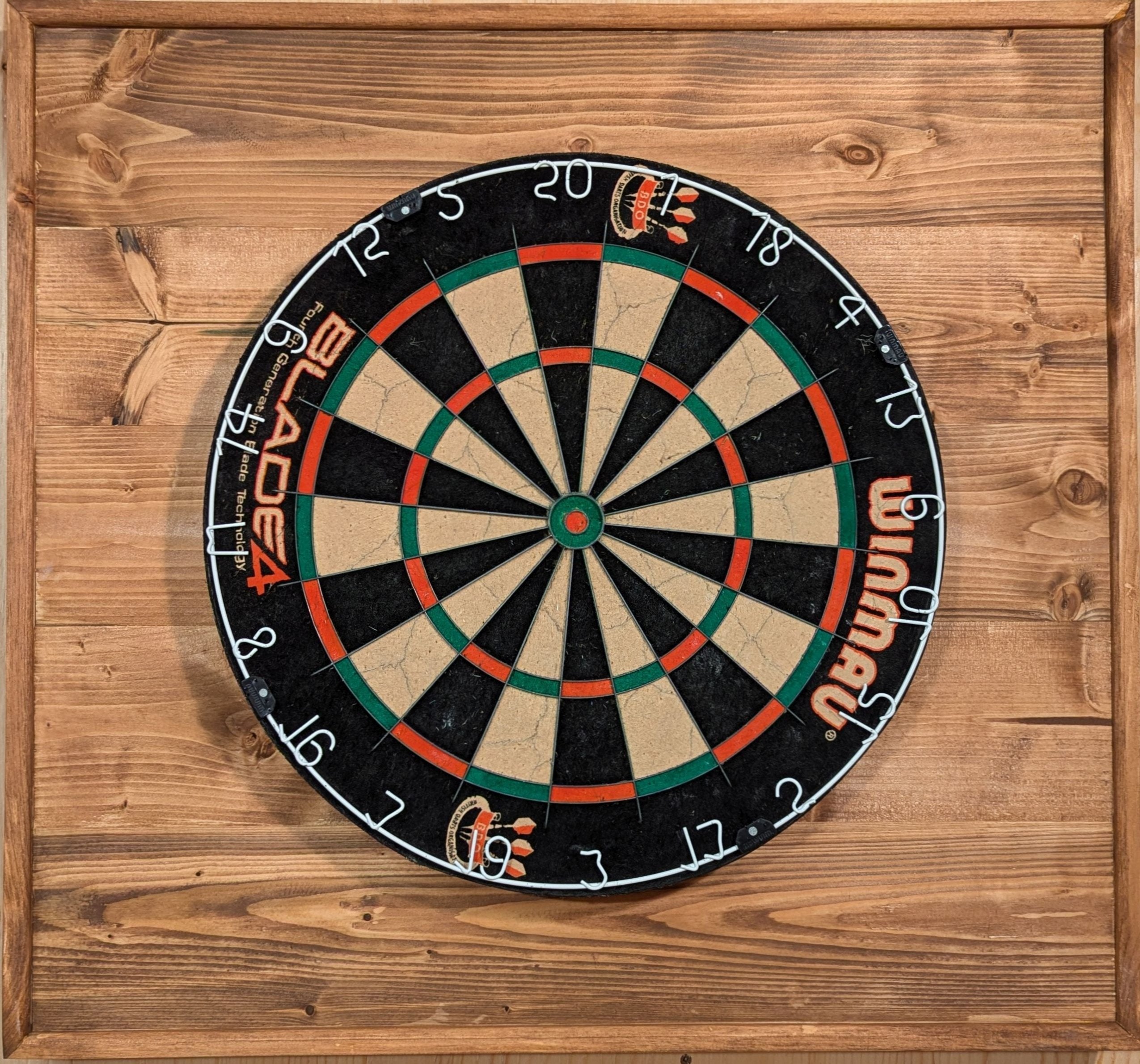 A darts backboard finished in special walnut. 